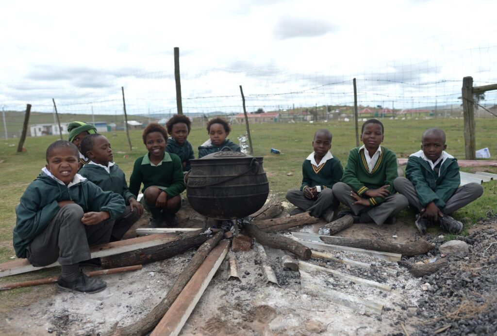 School children cooking pot