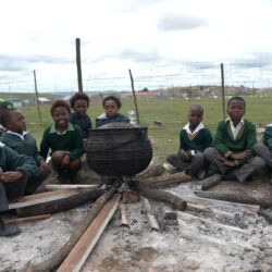 School children cooking pot